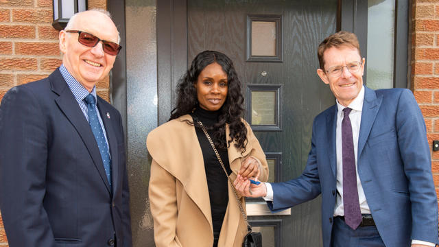 Midland Heart board chair with Andy Street and a tenant receiving the key to her new home