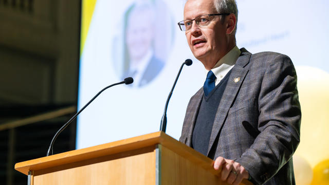 Glenn speaking at the podium