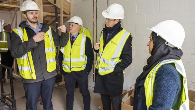 Midland Heart employees inside a house talking about the construction