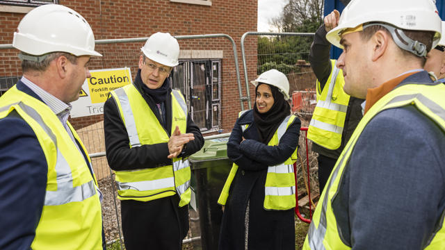 Glenn speaking with people while everyone is wearing high vis jackets and hard hats