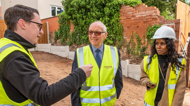 The Midland Heart board chair speaking with a tenant and a Midland Heart employee