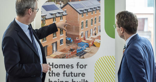 Glenn with Andy Street, looking at a banner showing the homes being built