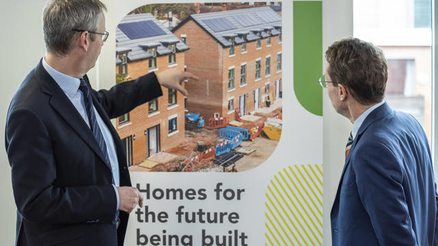 Glenn with Andy Street, looking at a banner showing the homes being built