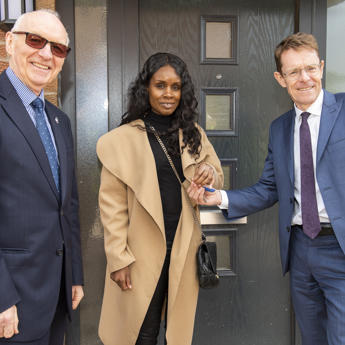 Board Chair and Birmingham Mayor with a tenant moving into their new home