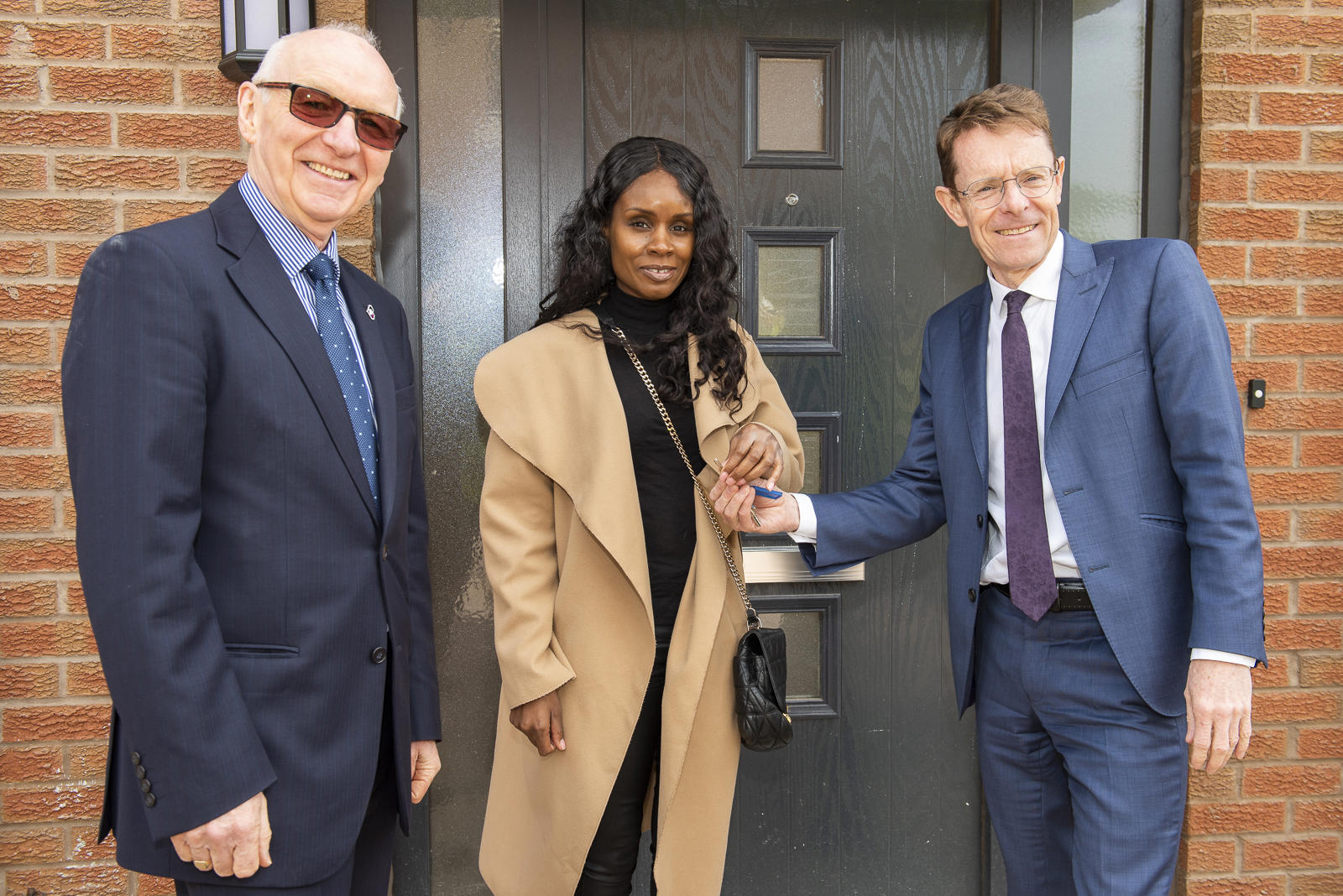 Board Chair and Birmingham Mayor with a tenant moving into their new home